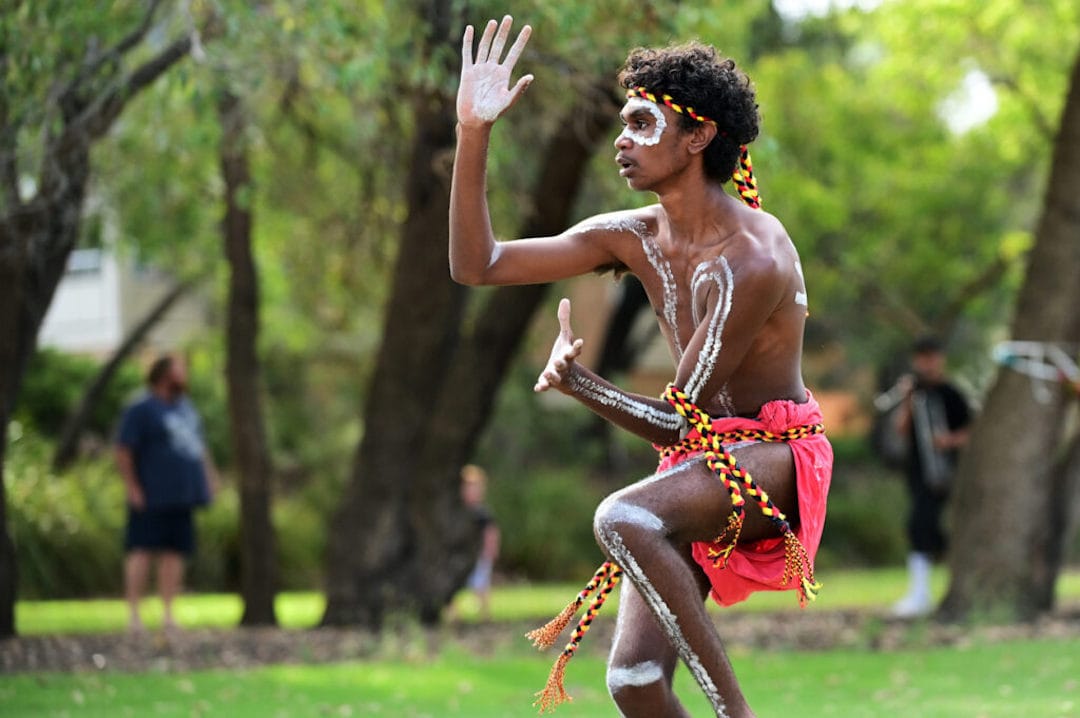 Aboriginal Australians man dancing traditional dance during Australia Day celebrations