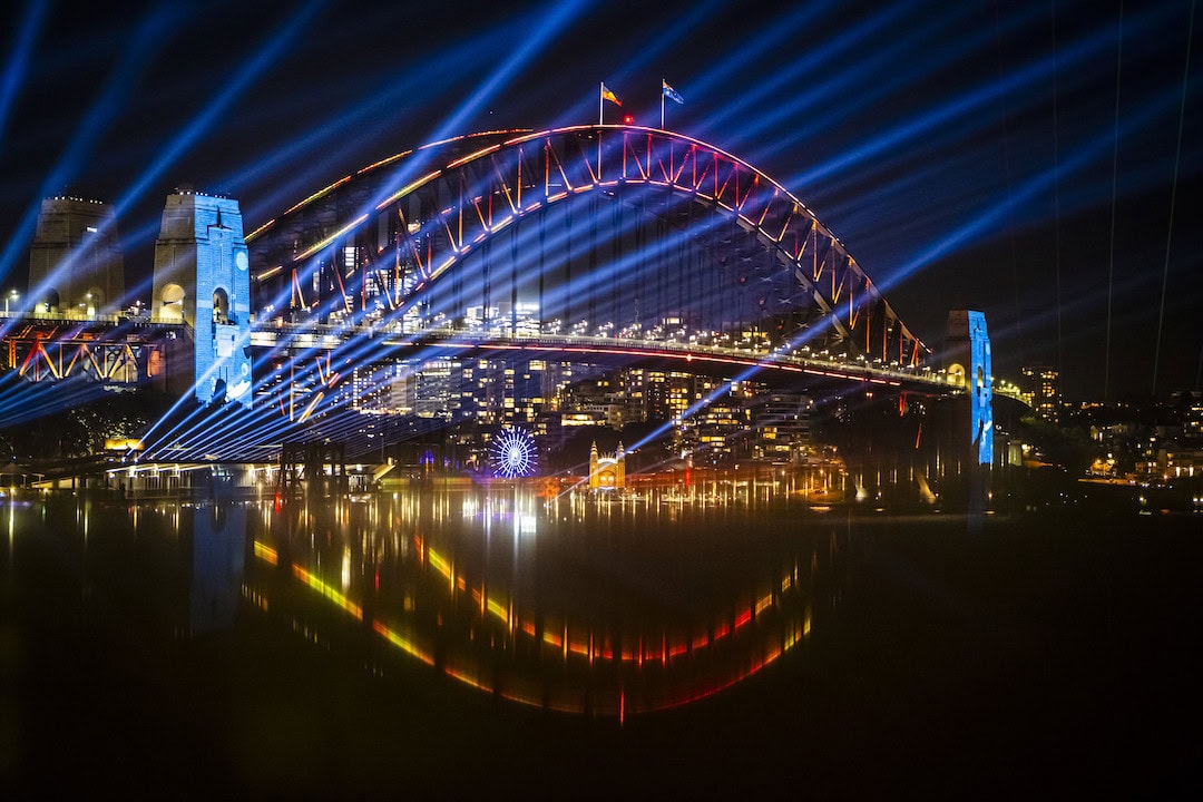 Our City Connected brings our city together through light. On every other day of the year, Sydney’s buildings stand on their own. During Vivid Sydney the city’s architecture and the Sydney Harbour Bridge are brought together as a canvas for dynamic lasers and searchlights. Artist: Mandylights