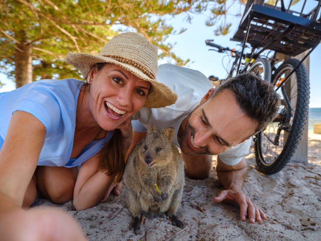 Couple taking selfie with Quokka. Image: Tourism Western Australia.